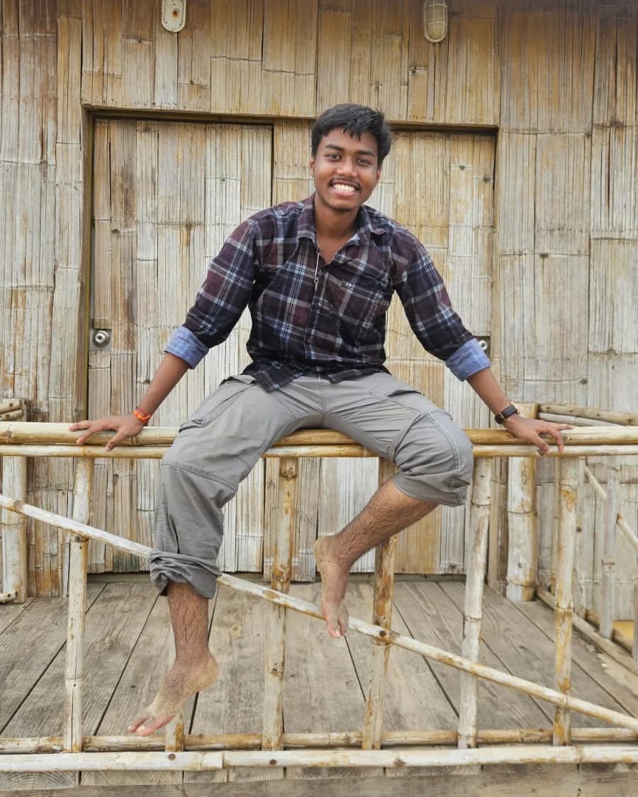 Sitting on a bamboo railing by the beach
